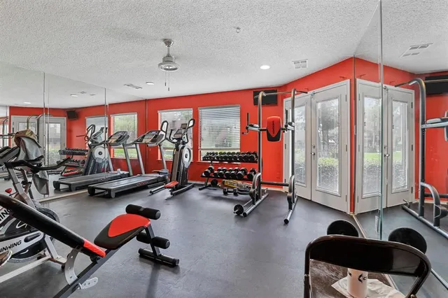 a room with gym equipment and a large window