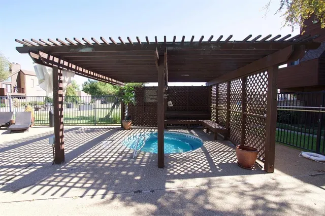 a view of a patio with table and chairs with wooden floor and fence