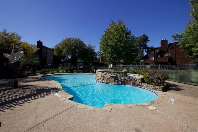 a view of a swimming pool with a patio
