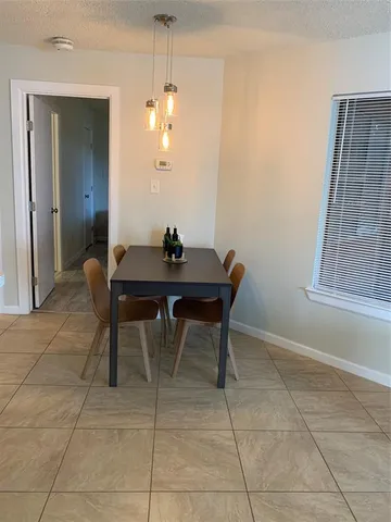 a dining room with a table and chairs