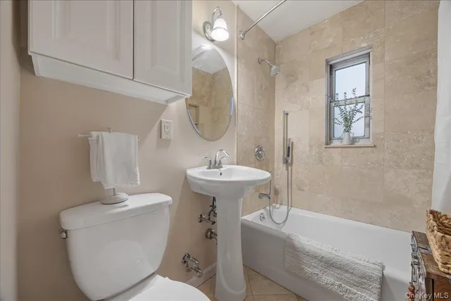 a bathroom with a sink a toilet and bathtub
