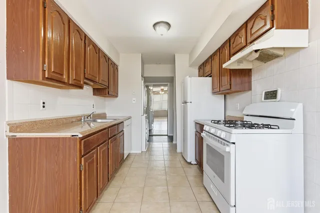 a kitchen with stainless steel appliances granite countertop a stove and a sink