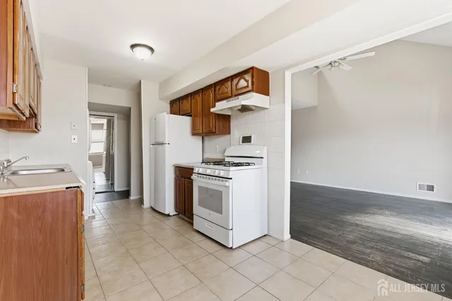 a kitchen with a stove and a refrigerator