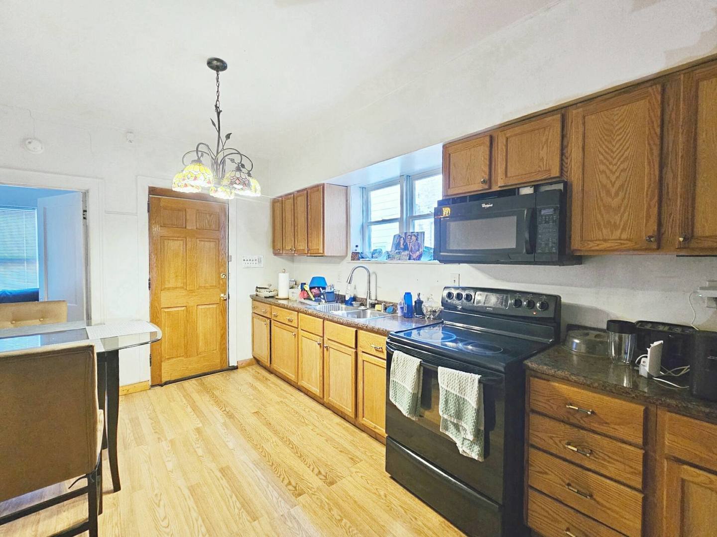 7949 South Rhodes Avenue Chicago, IL 60619 - Photo 12 of 14 a kitchen with stainless steel appliances granite countertop a sink stove and refrigerator