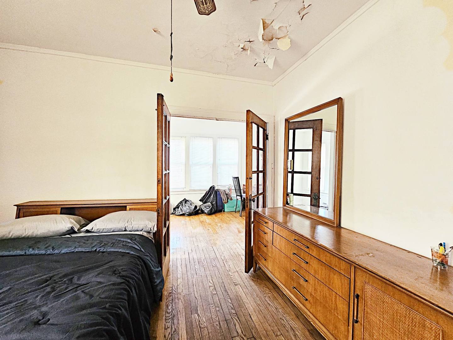 7949 South Rhodes Avenue Chicago, IL 60619 - Photo 5 of 14 a spacious bedroom with a bed and a window