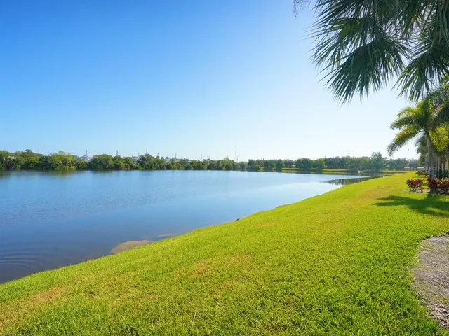 a view of a lake with houses in the back