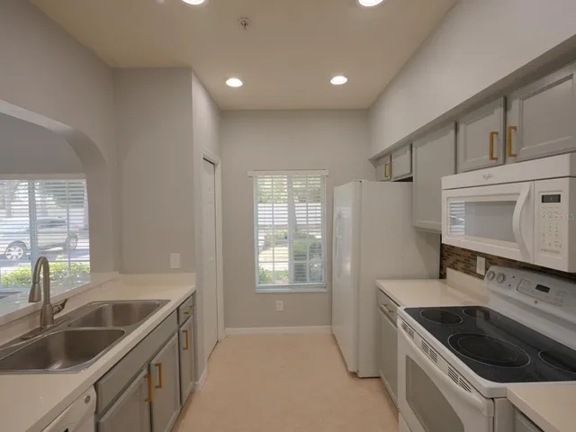 a kitchen that has a sink and a stove in it