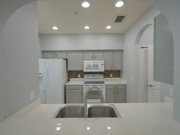 a kitchen with a sink a stove and refrigerator