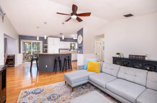 a living room with furniture and kitchen view