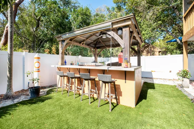 a view of backyard with sitting area and slide