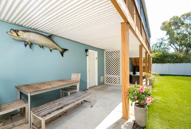 a backyard of a house with outdoor seating