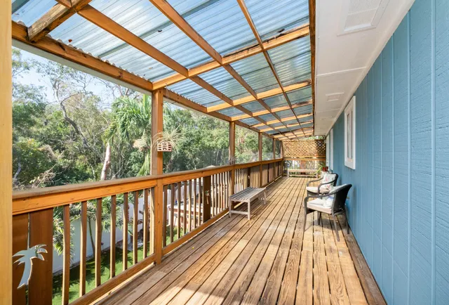a view of balcony with wooden floor