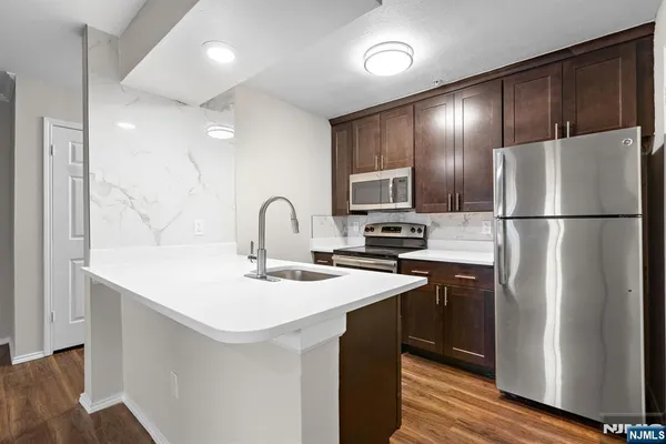 a kitchen with refrigerator a sink and cabinets