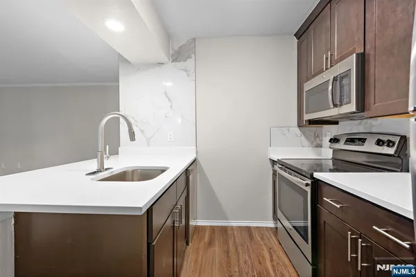 a kitchen with sink a microwave and stove