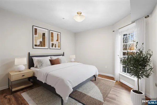 a bedroom with a bed and a potted plant