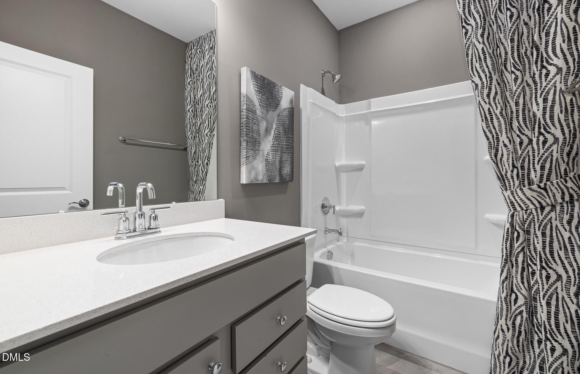 413 Grange Farm Place Raleigh, NC 27603 - Photo 19 of 33 a bathroom with a sink a toilet and a bathtub