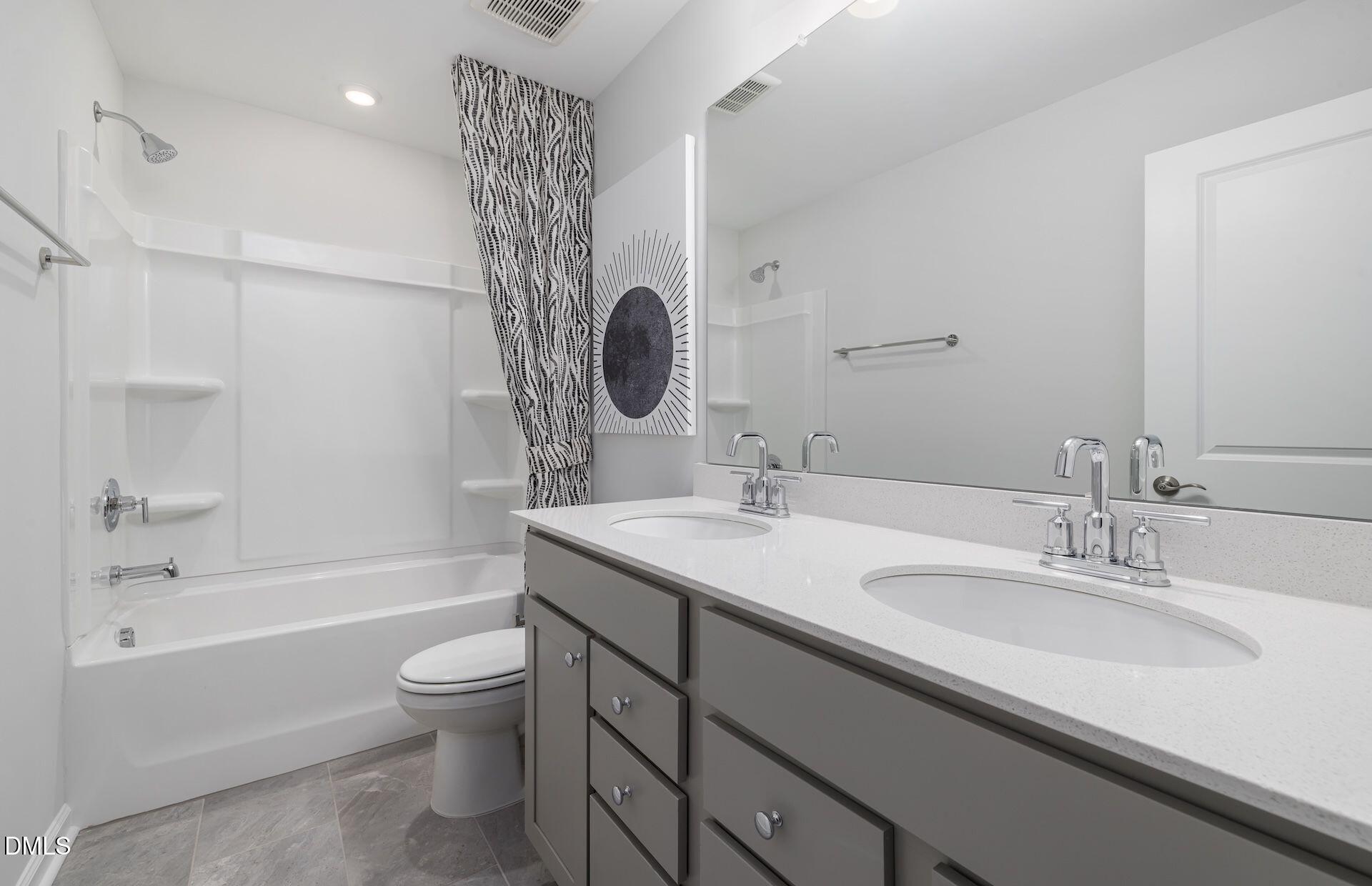 413 Grange Farm Place Raleigh, NC 27603 - Photo 21 of 33 a bathroom with a granite countertop sink a toilet and bathtub