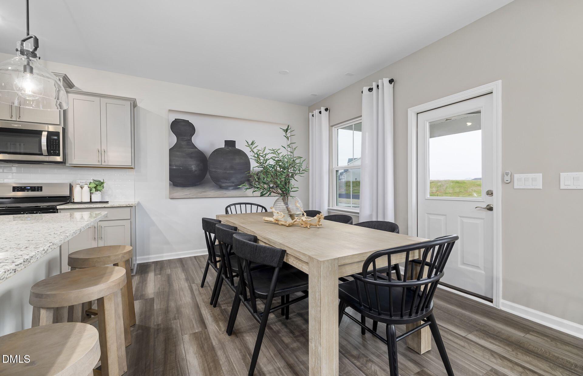 413 Grange Farm Place Raleigh, NC 27603 - Photo 5 of 33 a view of a dining room with furniture window and wooden floor