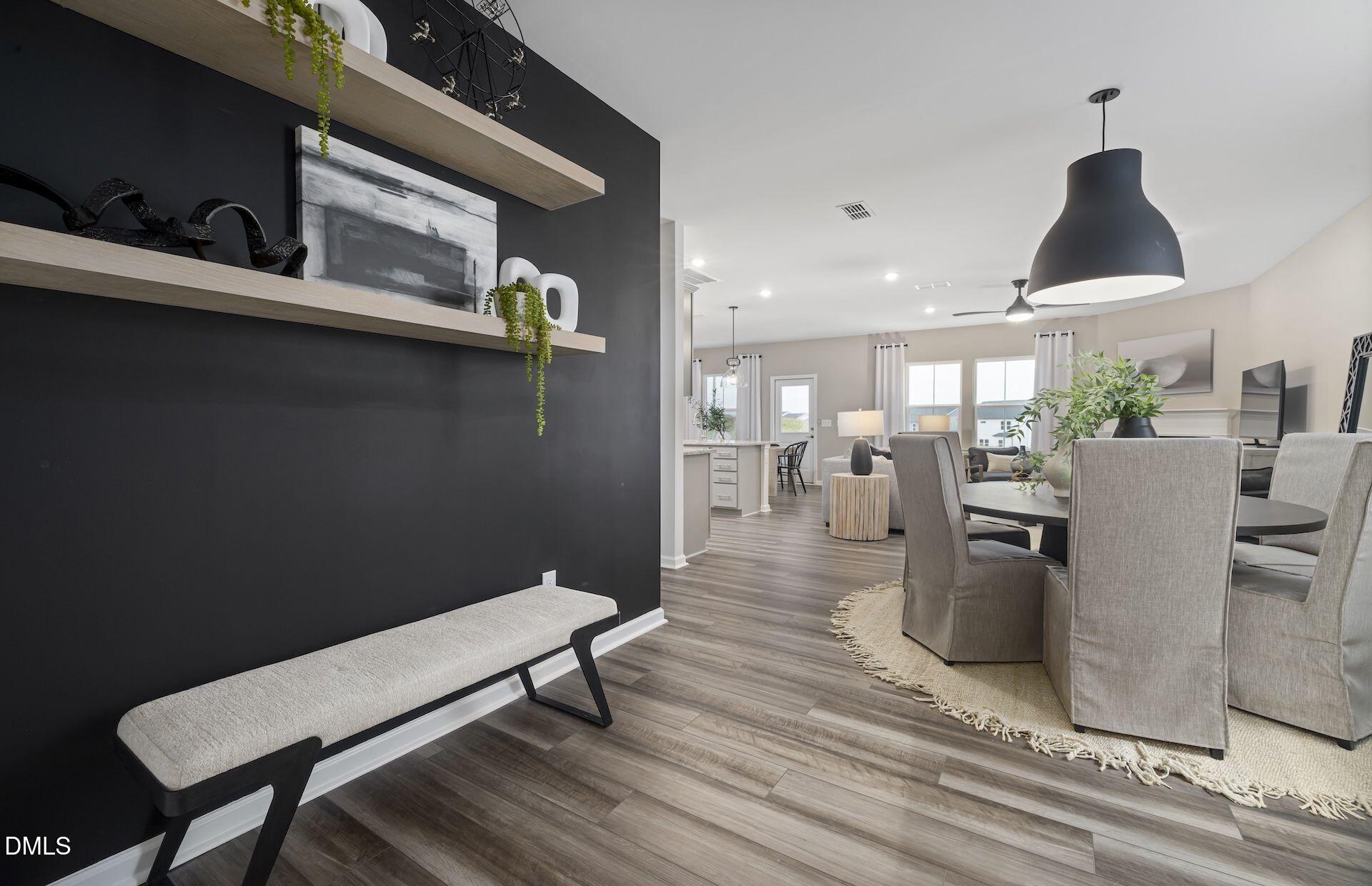 413 Grange Farm Place Raleigh, NC 27603 - Photo 7 of 33 a living room with furniture a table and kitchen view