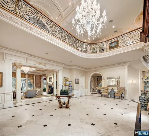 a view of a hallway with a chandelier and livingroom view