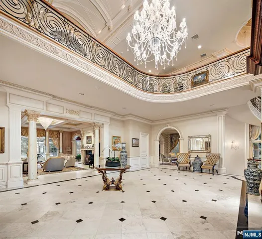a view of a hallway with a chandelier and livingroom view