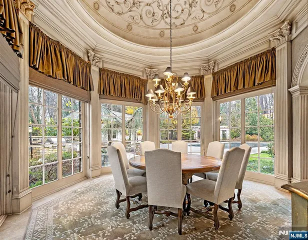 a room with lots of furniture and chandelier