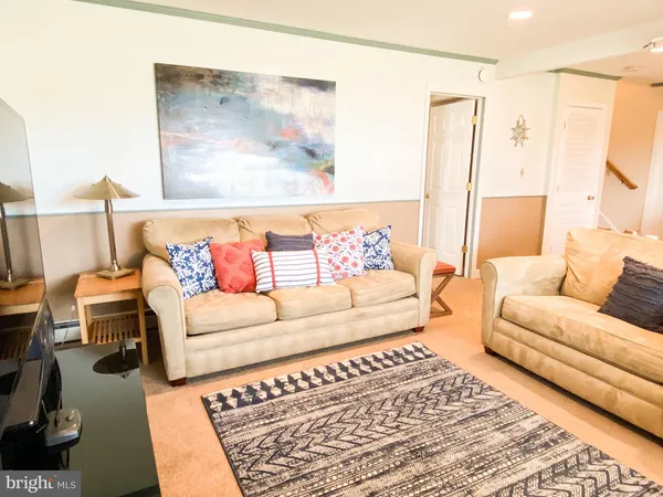 a living room with furniture and a rug