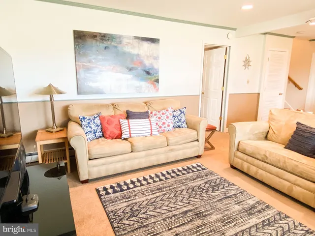 a living room with furniture and a rug