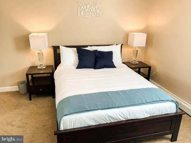 a bedroom with a bed and a lamp