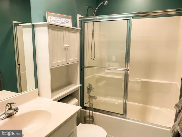 a bathroom with a shower and a sink