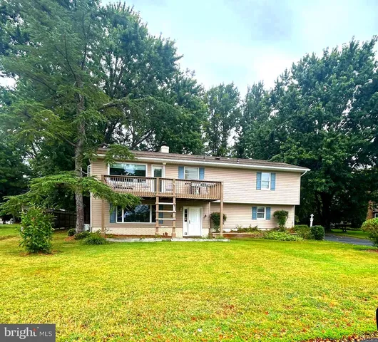 a view of a house with a yard balcony and swimming pool
