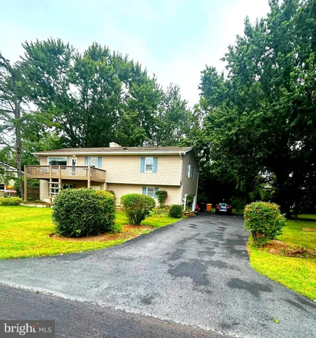 a view of a house with pool and a yard