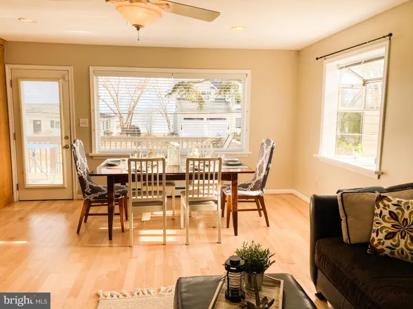 a view of a dining room with furniture wooden floor and a flat screen tv