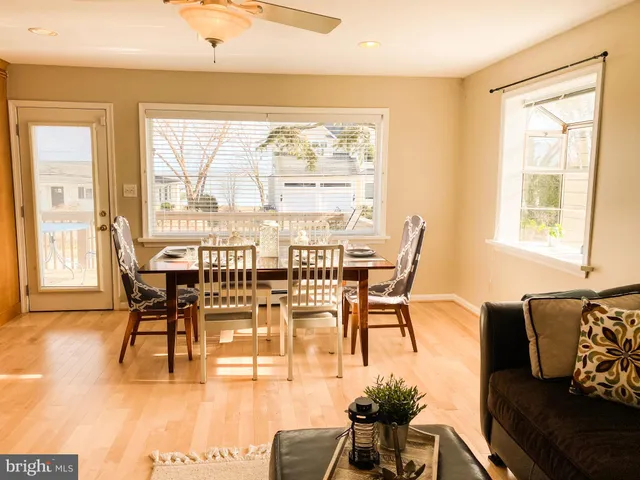 a view of a dining room with furniture wooden floor and a flat screen tv
