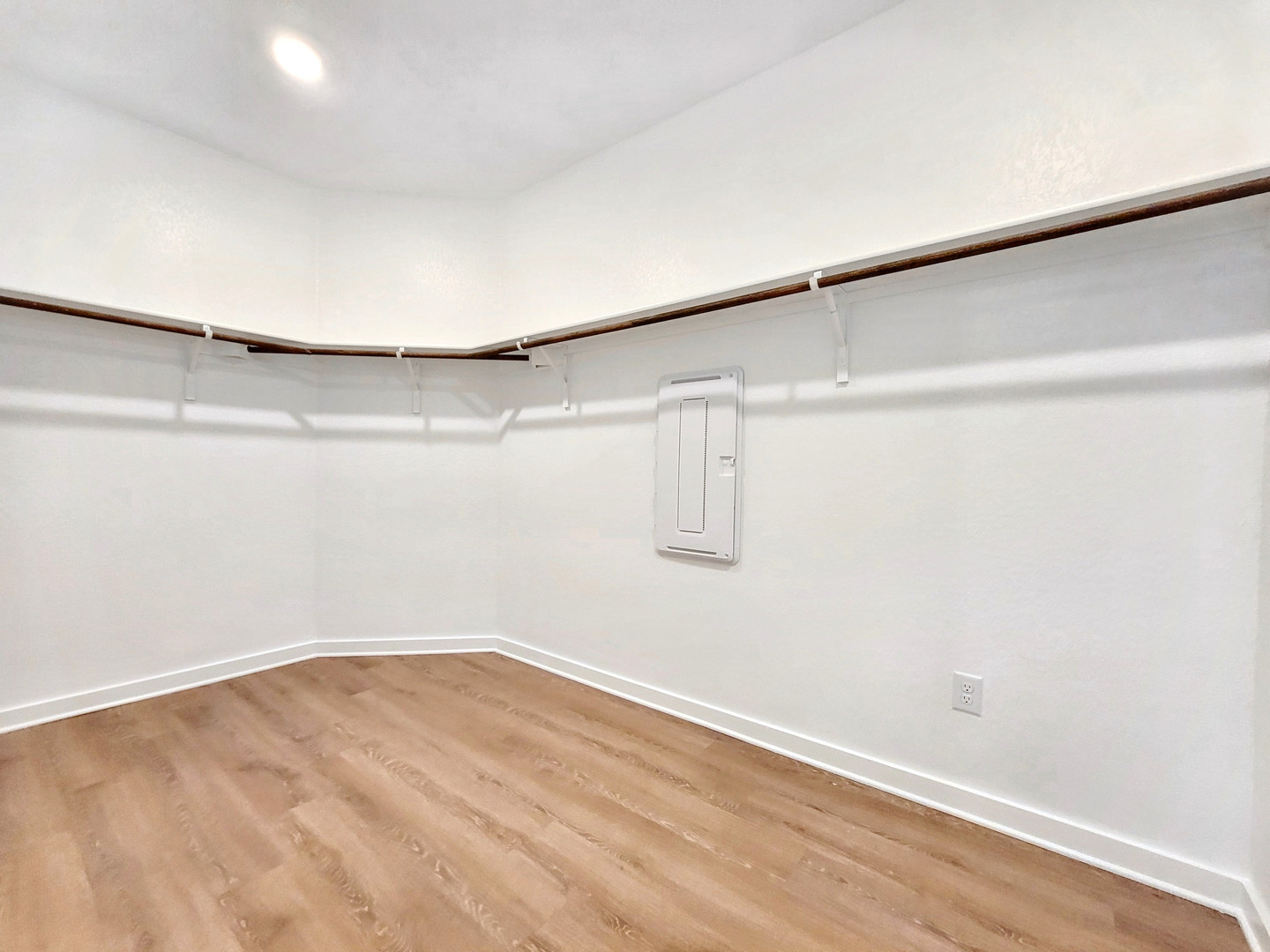 2329 Gabriels Horn Road Leander, TX 78641 - Photo 13 of 23 Ample hanging space and light wood-style flooring characterize this well-lit walk-in closet.