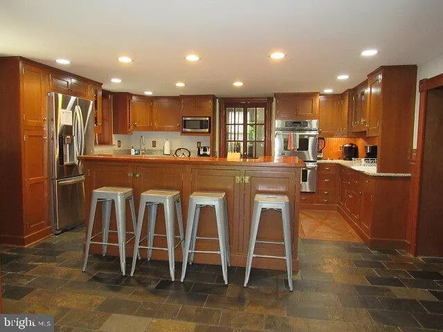 a living room with furniture ceiling fan and a window