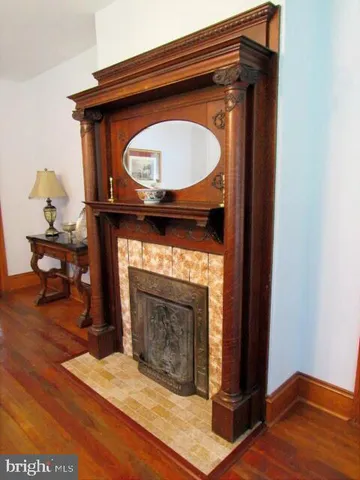 a bedroom with a bed and a lamp with the dresser