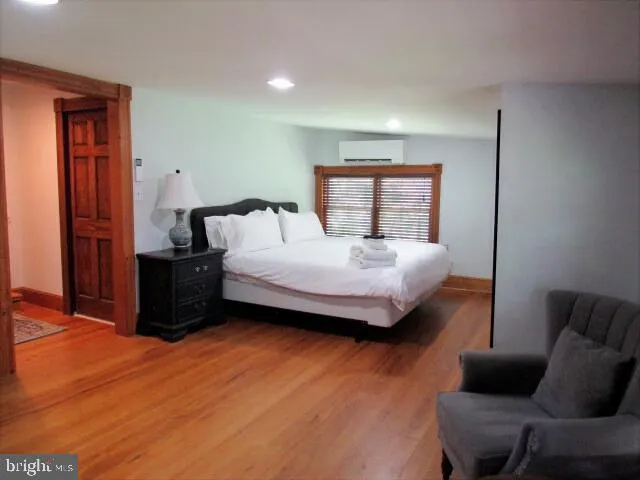 a backyard of a house with plants and large tree