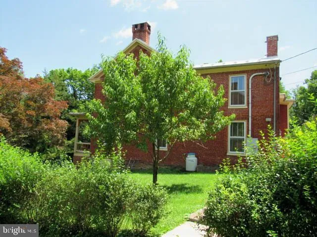 a front view of a house with a yard and fence