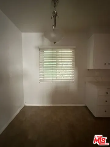 an empty room with a empty space and windows