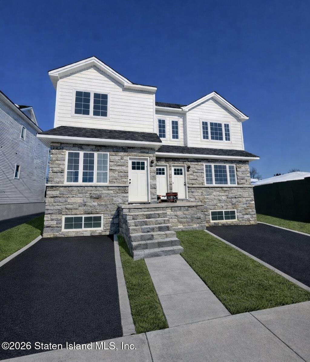 4693 Amboy Road Staten Island, NY 10312 - Photo 1 of 3 a front view of a house with a yard