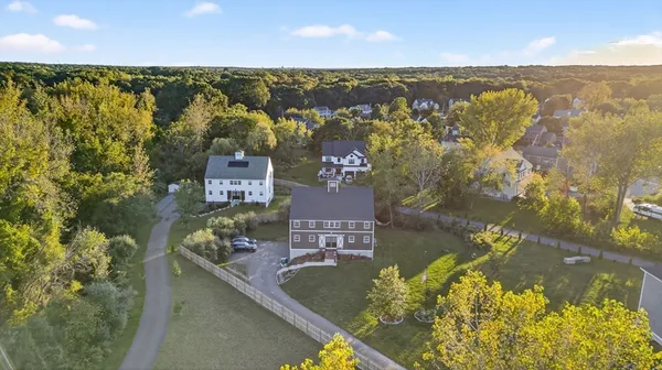 an aerial view of residential houses with outdoor space and swimming pool