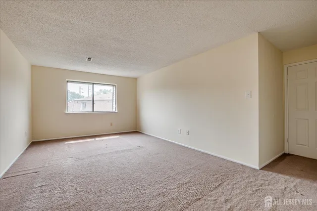 a view of an empty room and a window