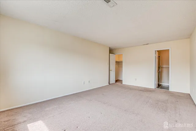 a bathroom with a granite countertop sink toilet and a mirror