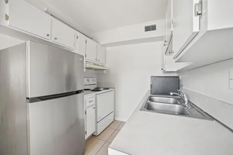 a kitchen with stainless steel appliances a refrigerator and a stove