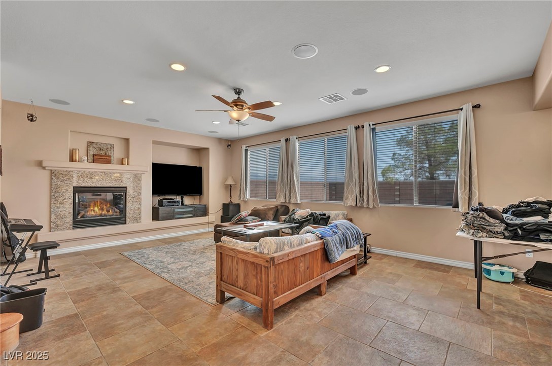 8208 Seven Falls Street North Las Vegas, NV 89085 - Photo 14 of 69 Living area featuring a fireplace, recessed lighting, and a ceiling fan
