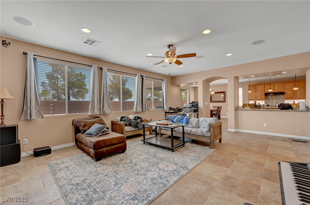 8208 Seven Falls Street North Las Vegas, NV 89085 - Photo 18 of 69 Living room with a ceiling fan, recessed lighting, and arched walkways