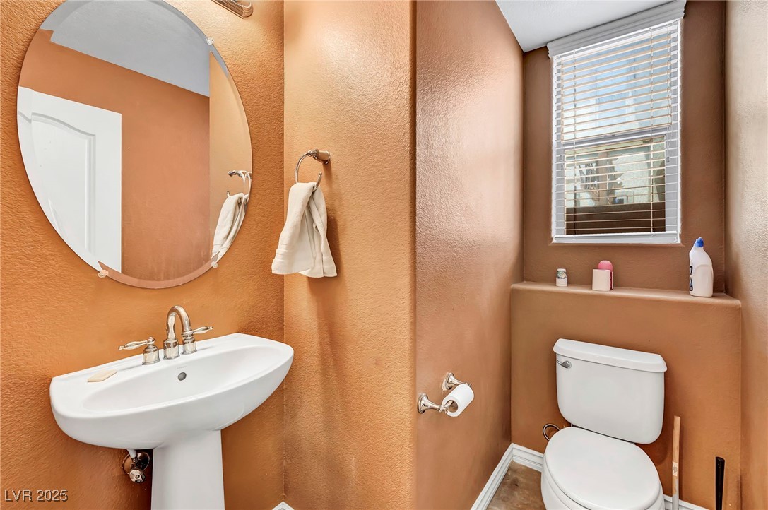 8208 Seven Falls Street North Las Vegas, NV 89085 - Photo 19 of 69 Half bathroom with a textured wall and toilet