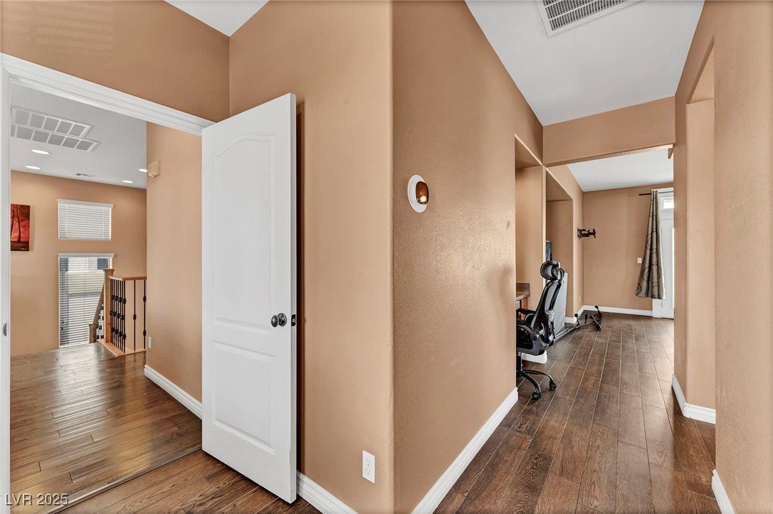 8208 Seven Falls Street North Las Vegas, NV 89085 - Photo 25 of 69 Hall featuring hardwood / wood-style floors and an upstairs landing