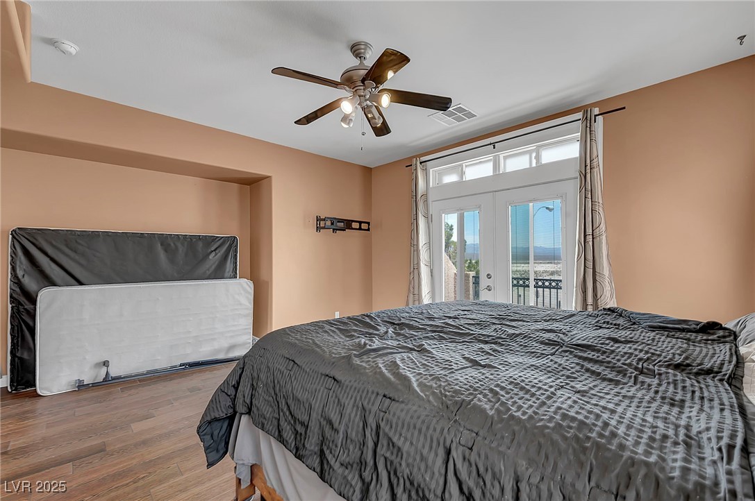 8208 Seven Falls Street North Las Vegas, NV 89085 - Photo 35 of 69 Bedroom featuring access to exterior, french doors, wood finished floors, and a ceiling fan